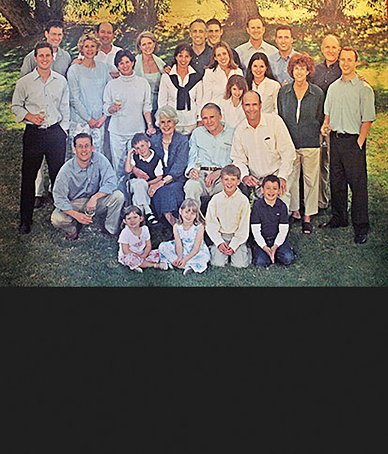 In 1989 the Klein family stands smiling in a large group on a dark green lawn