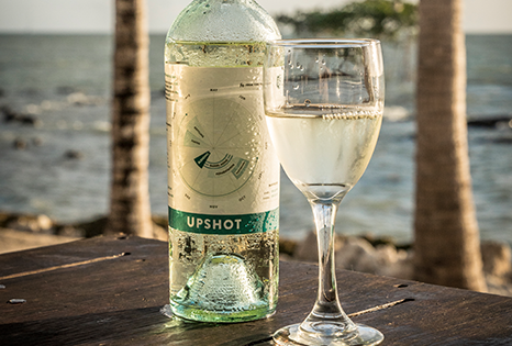 Glass and bottle of Upshot white blend