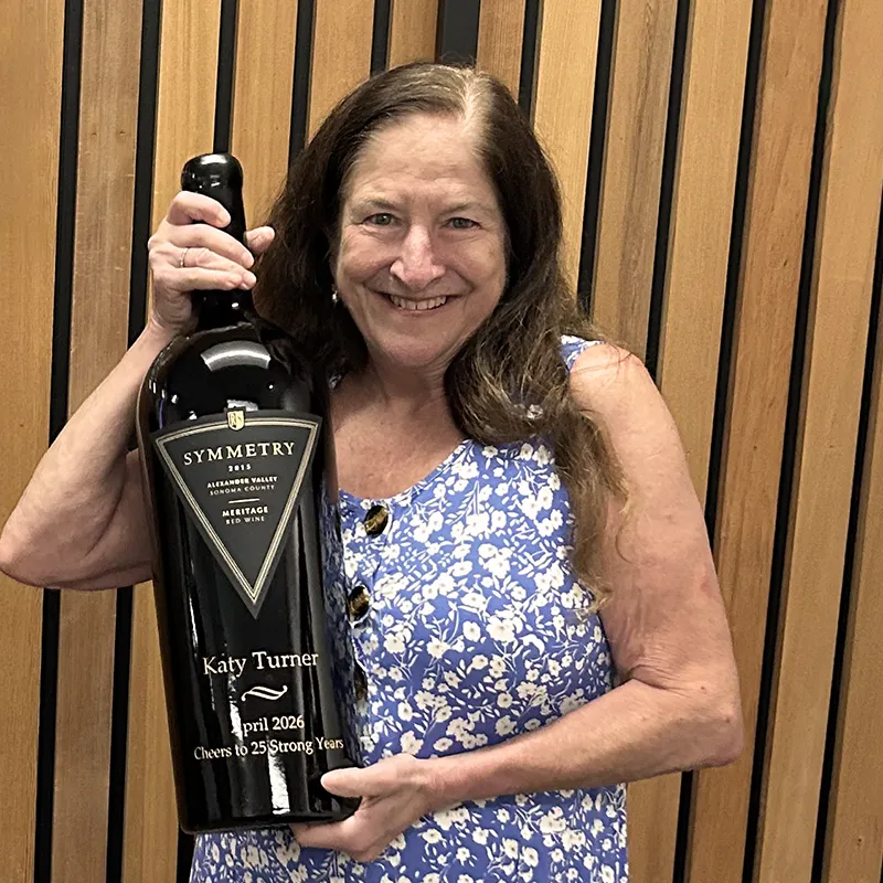 Katy Turner holding a large bottle of Katy's Blend Symmetry
