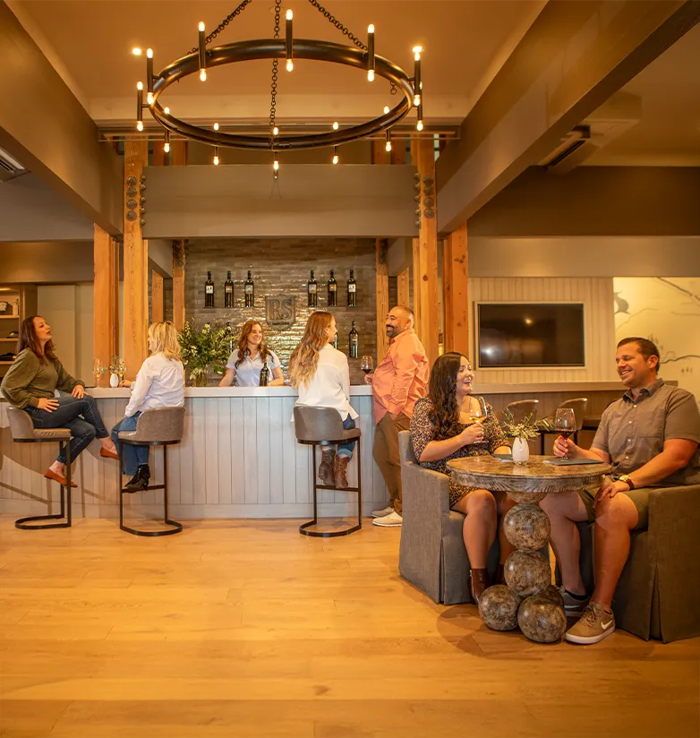 People enjoying wine in the tasting room